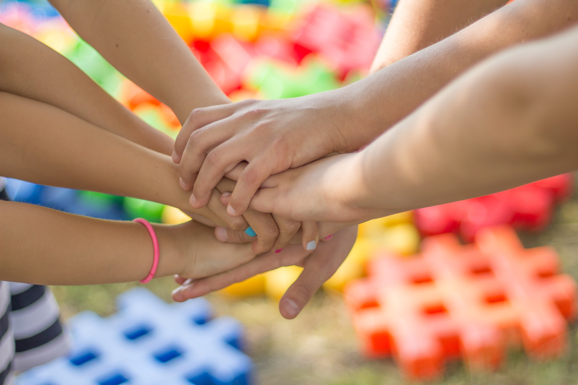 childrens hands outreached and joining in a circle